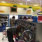 People using the front load washing machines at the free laundry event sponsored by to Laundry Love QC at Laudromania Davenport