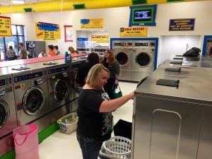 People using the washing machines during the free laundry event