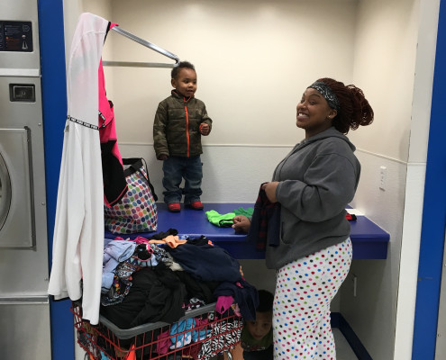 Mother and children at Free Laundry Event on Wednesday March 2nd at Laundromania in Davenport, Iowa