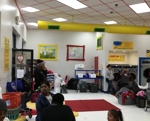 Families waiting for laundry at Free Wednesday event