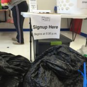 Signup here table for Laundry Love QC free laundry event at Laundromania in Davenport