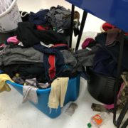 Laundry on the floor at Laundromania's Free Laundry Event in October