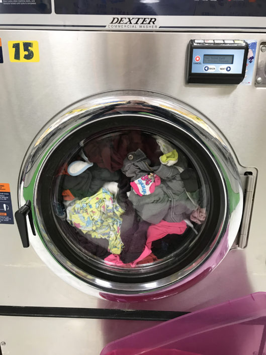 Washing machine with clothes at Laundry Love QC event at Laundromania in Davenport, Iowa