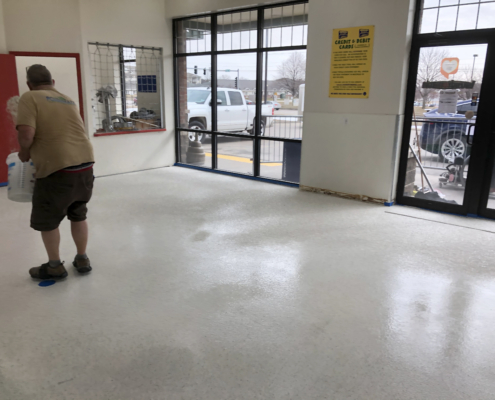 Sprinkles going on the flooring is installed at the Davenport Laundromania laundromat location
